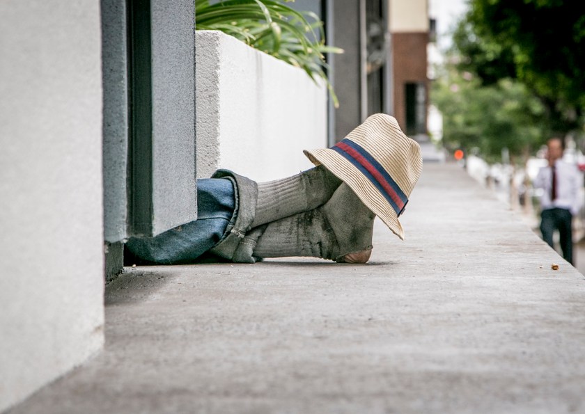 A homeless man extends his feet while napping along the side of a building on New Hampshire Avenue and Wilshire Boulevard, part of the the area’s financial sector. The image captures one of my themes: a man's feet in haggard socks are veiled by a stylish fedora, a symbol for a veiled subsection of the area’s population that lives in poverty but remains unseen and unrepresented.