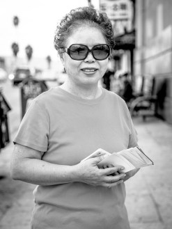 Younny was passing out flyers for her church on the corner of Olympic Boulevard and Western Avenue. She moved to Los Angeles in 1977 and currently lives in Pasadena but travels to Koreatown every week to go to church and see her daughter who lives there. She said its easy to live in Koreatown because it is familiar. She said since she had started visiting Koreatown, the biggest changes she had seen were more buildings and markets