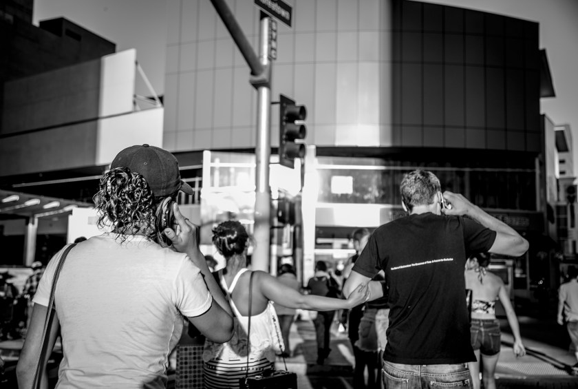 Bystanders cross the street leading to the Metro Station on Western Avenue and Wilshire Boulevard
